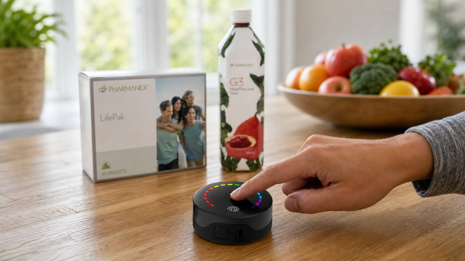 A fingertip uses a PRYSM iO scanner in the foreground while a LifePak box and g3 juice bottle sit softly focused in the background.